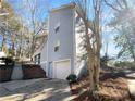 Side view of house with attached garage and a walkway at 6049 Shallow Wood Ct, Douglasville, GA 30135
