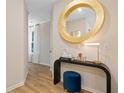 Stylish entryway with a gold mirror, console table, and blue ottoman at 891 Eagle Ave, Riverdale, GA 30274