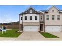 Modern townhome with a neutral color palette and manicured lawn for enhanced curb appeal at 891 Eagle Ave, Riverdale, GA 30274