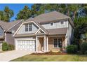 Two-story house with gray siding, brick accents, and a two-car garage at 230 Ascott Ln, Woodstock, GA 30189