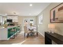 Modern dining area with a round table and four chairs, adjacent to the kitchen at 2716 Riggs Dr, East Point, GA 30344