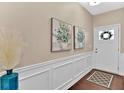 Bright and airy entryway with wainscoting and hardwood floors at 2805 Ellis Pointe Ave, Conyers, GA 30094