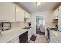 White kitchen cabinets, gas stove, and dishwasher at 1803 Ashborough Way # Apt F, Marietta, GA 30067