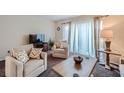 Living room with two armchairs, coffee table, and TV at 1803 Ashborough Way # Apt F, Marietta, GA 30067