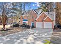 Two-story brick home with a two-car garage and driveway at 2464 Insdale Nw Trce, Acworth, GA 30101