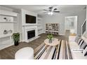 Virtually staged living room with fireplace and built-in shelving at 1710 Garbrooke Cv, Lawrenceville, GA 30046