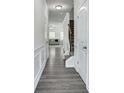 Bright hallway with gray flooring and white trim, leading to the living area and staircase at 204 Hickory Commons Way, Canton, GA 30115