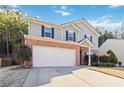 Two-story house with brick and siding, a large yard, and a two-car garage at 6397 Barker Station Walk, Sugar Hill, GA 30518