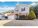 Two-story house with brick and siding, a large yard, and a two-car garage at 6397 Barker Station Walk, Sugar Hill, GA 30518