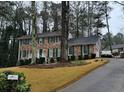 Two-story brick home with green shutters and a large yard at 714 Weatherborn Pl, Stone Mountain, GA 30083