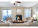 Living room with fireplace, hardwood floors, and access to deck at 1355 N Crossing Dr, Atlanta, GA 30329