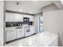 White kitchen with modern appliances and granite countertops at 3948 Cedar Cir, Tucker, GA 30084