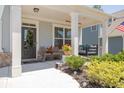 Front porch with a swing, wicker chairs, and potted plants at 121 Treeline Trl, Canton, GA 30115