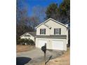 Two-story house with a two-car garage, mailbox, and mature trees at 3575 Oakvale Falls Ct, Decatur, GA 30034