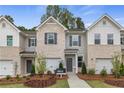 Curb appeal abounds in this townhome community featuring attached garages and landscaping at 451 Payne Dr, Mcdonough, GA 30253