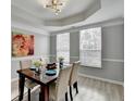 Dining room with gray walls, wood-look floors, and a wood dining table at 5102 Anclote Dr, Alpharetta, GA 30022