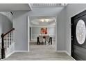 Bright entryway with gray walls, wood-look floors, and view to dining area at 5102 Anclote Dr, Alpharetta, GA 30022