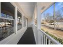 Bright and airy front porch with white railings and view of neighborhood at 380 Atwood Nw Dr, Marietta, GA 30064