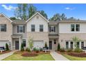 Two-story townhome featuring brick and siding exterior at 447 Payne Dr, Mcdonough, GA 30294