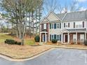 Two-story townhome with brick and siding, showcasing a walkway and parking area at 900 Tree Creek Blvd, Lawrenceville, GA 30043