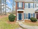 Front view of a two-story townhome with a navy blue door and brick accents at 900 Tree Creek Blvd, Lawrenceville, GA 30043