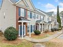 Row of townhomes with brick and siding, displaying consistent architectural style at 900 Tree Creek Blvd, Lawrenceville, GA 30043