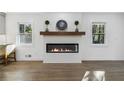 Modern fireplace with white brick surround and wood mantel at 2359 Melinda Ne Dr, Atlanta, GA 30345