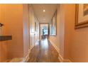 Hallway with artwork and hardwood floors leading towards rooms at 3630 Peachtree Ne Rd # 2706, Atlanta, GA 30326