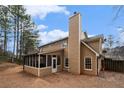 Tan house with a screened porch and chimney at 4308 Glenlake Court Northwest, Kennesaw, GA 30144