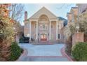 Brick home with a circular driveway and manicured landscaping at 1401 Walcutts Nw Way, Marietta, GA 30064