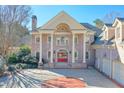 Brick home with grand entrance, columns and red doors at 1401 Walcutts Nw Way, Marietta, GA 30064