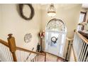 Foyer and staircase with views to a stained glass transom over front door at 230 Cobblestone Ln, Mcdonough, GA 30252