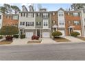 Townhome exteriors with individual garages and varied brick, siding, and stone accents at 3044 Lauren Parc Rd, Decatur, GA 30032