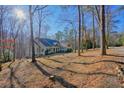 Rear exterior showcasing the home's serene wooded surroundings and privacy at 159 Geneva Rd, Canton, GA 30114