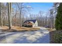 Beautiful home featuring a long driveway and a private, wooded lot at 159 Geneva Rd, Canton, GA 30114