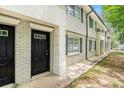Well-maintained building exterior with brick facade and landscaping at 6940 Roswell Rd # 16B, Atlanta, GA 30328