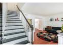 Modern staircase with black and white painted risers and wood handrail at 6940 Roswell Rd # 16B, Atlanta, GA 30328