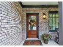 Inviting front entrance with a wooden door, brick facade, and potted plants at 1849 8Th St, Atlanta, GA 30341