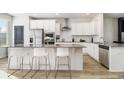 Modern kitchen with white cabinets, stainless steel appliances, and an island at 200 Wallace St, Fayetteville, GA 30214