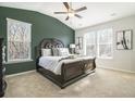 Large main bedroom with green accent wall and high ceilings at 200 Wallace St, Fayetteville, GA 30214