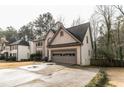 Two-story house with attached garage and driveway, surrounded by trees at 2543 Laurel View Ct, Snellville, GA 30078