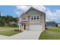Two-story brick home with a two-car garage and landscaped lawn at 75 Barge Ln, Covington, GA 30016