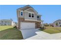 Two-story home with gray siding, brick accents, and a two-car garage at 247 Tulip Dr, Covington, GA 30016