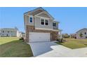 Two-story house with gray siding, brick accents, and a two-car garage at 258 Tulip Dr, Covington, GA 30016