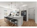Modern white kitchen with stainless steel appliances and a large island at 3576 Silvery Way, Powder Springs, GA 30127