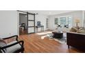 Spacious living room with wood floors, large windows, and stylish decor at 6851 Roswell Rd # N-20, Sandy Springs, GA 30328