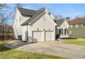 Home exterior featuring a two-car garage and well-maintained lawn at 9776 Spyglass Dr, Villa Rica, GA 30180