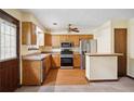 Galley style kitchen with wood cabinets, stainless steel appliances, and laminate flooring at 6698 Cameron Rd, Morrow, GA 30260