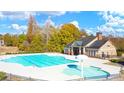Community pool and clubhouse surrounded by lush trees at 13490 Whitman Ln, Covington, GA 30014
