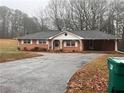 Brick ranch house with driveway and green bin at 4890 Prince Se Rd, Smyrna, GA 30082
